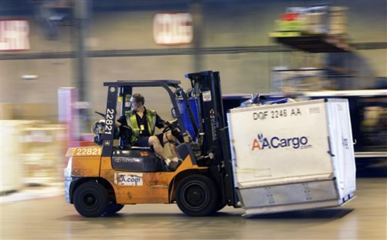 A fork lift moves a cargo container at the American Airline cargo processing warehouse at Dallas-Fort Worth International Airport in Grapevine, Texas.